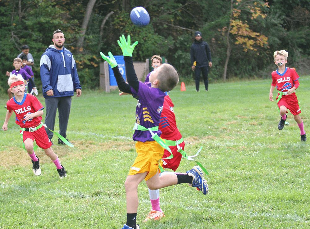 A young receiver leaps for a pass during a Rec game