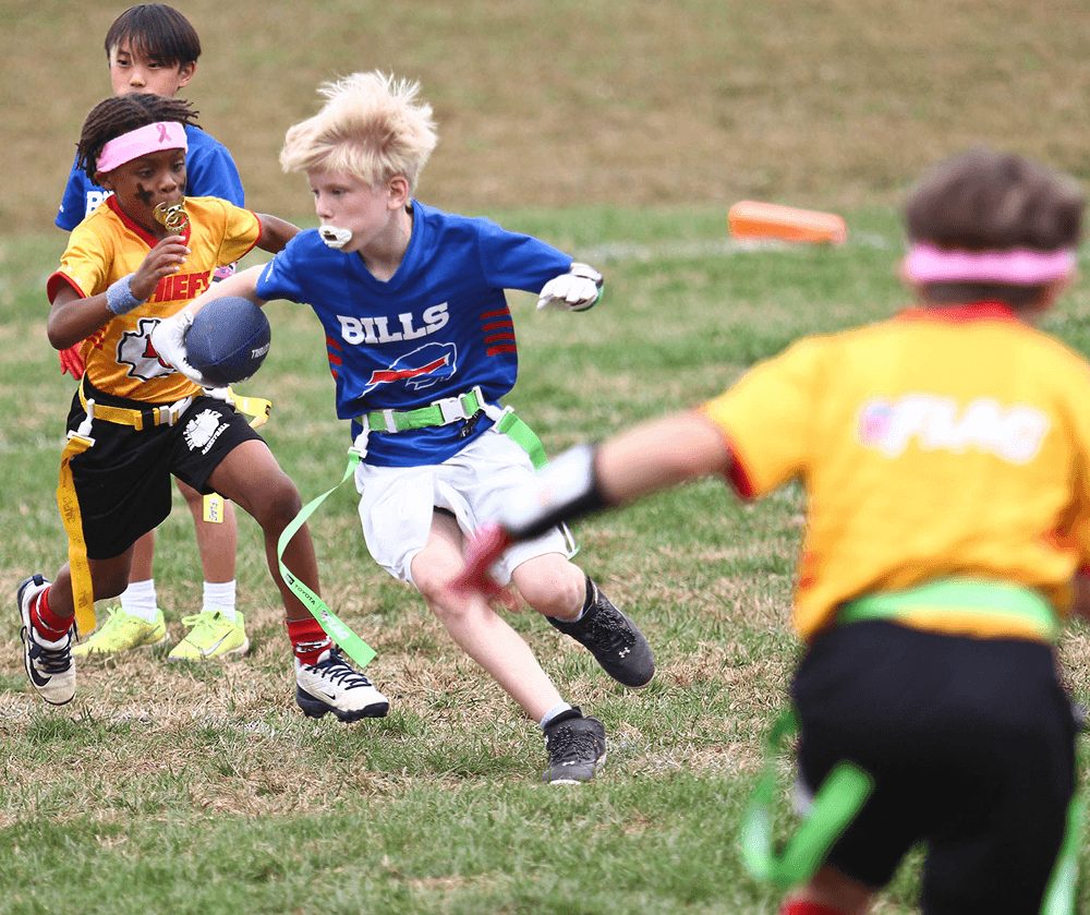 A receiver in blue goes up for the ball among defenders
