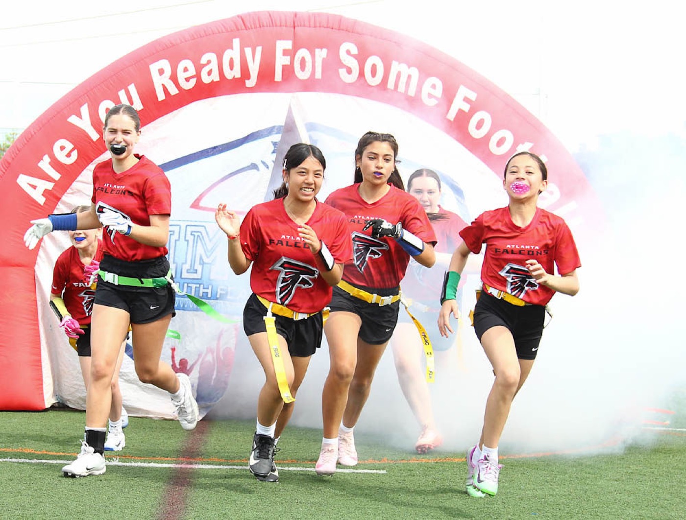 An All-Girls Falcons team runs out of the tunnel