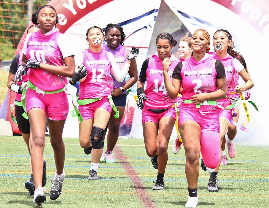 An All-Girls team runs out of the tunnel on game day