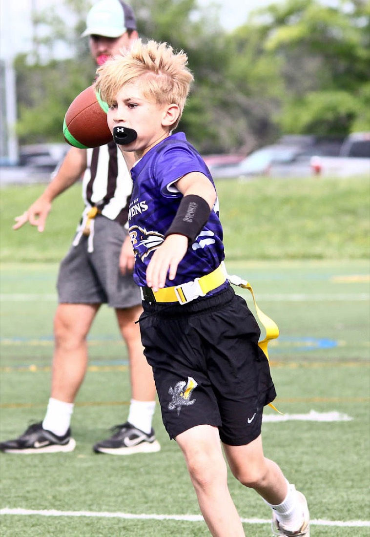 A young player runs with the ball during a Rec game